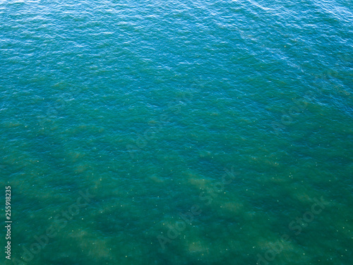 Ocean surface landscape from bird's eye drone view. Natural sea turquoise background. Copy space. Top view.