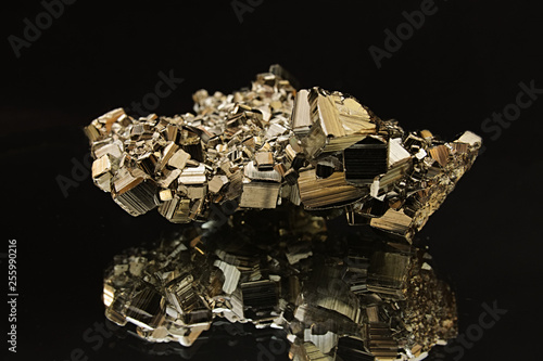 Mirror reflection of pyrite crystal on black background