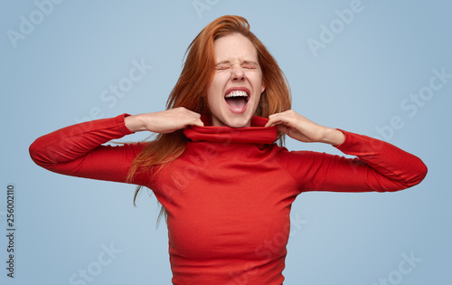 Screaming girl in tight sweater suffering 
