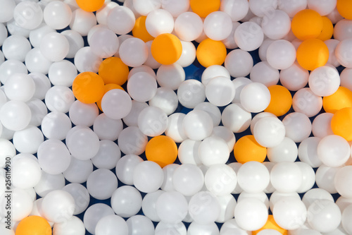 Ping pong balls mix of orange and white balls on a blue table background