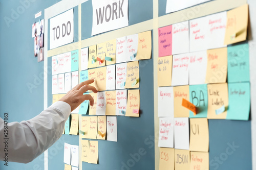 Young man near scrum task board in office