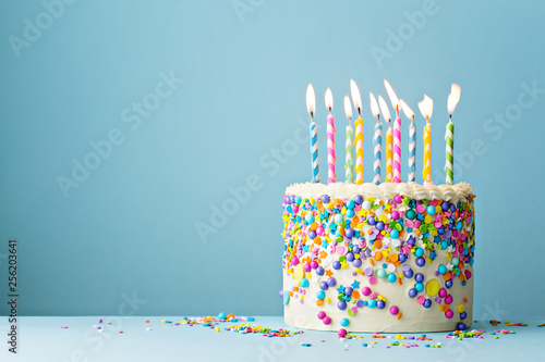 Birthday cake decorated with colorful sprinkles and ten candles