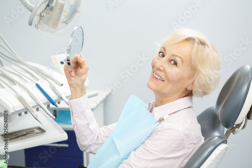 Happy senior woman at the dental clinic