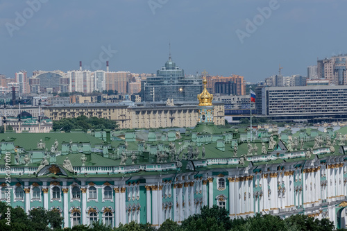 Building and green roof of the Hermitage with statues and Russian flag from a height, view of the city of St. Petersburg