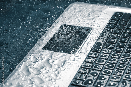 Laptop under the stream of water