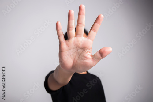 Hand of young man implying NO sign, rejecting expression or prevention