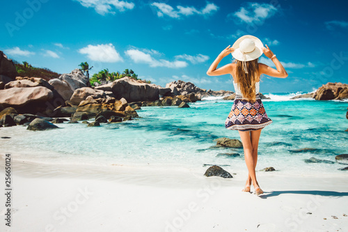 A young girl standing in shallow water on La Digue island, Seychelles