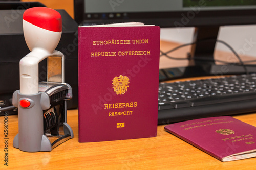 Close-up of Austrian biometric passport with a date stamper, interstate border in Europe. Inscription - European Union, Republic of Austria, Passport. Border crossing, travel, immigration concept