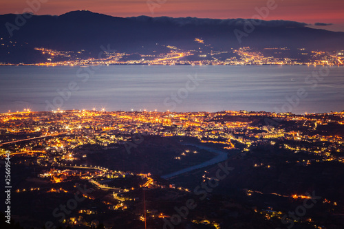 Messina strait and Reggio Calabria city lights at dusk