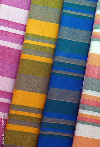 Closeup of folded striped bed sheets in display in a shop, for use as background