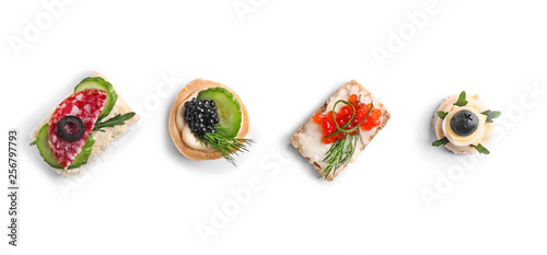 Assortment of tasty canapes on white background