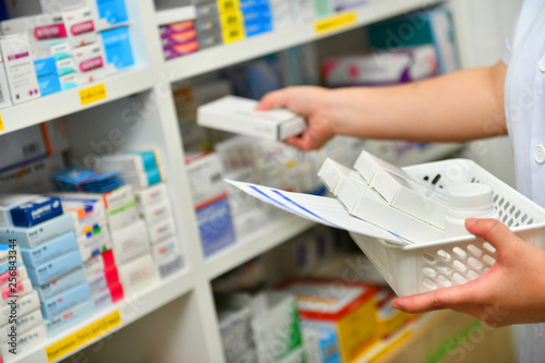 Pharmacist filling prescription in pharmacy drugstore