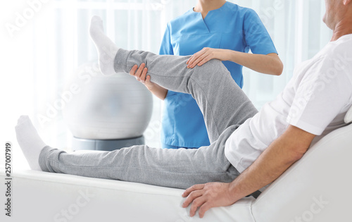 Doctor working with patient in hospital, closeup. Rehabilitation physiotherapy