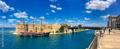 Overview of the Italian training ship Palinuro docked at the Aragonese Castle with a view of the navigable canal and the swing bridge of the city of Taranto, Puglia, Italy 