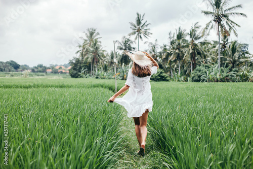 Young girl walking in rice field in Bali