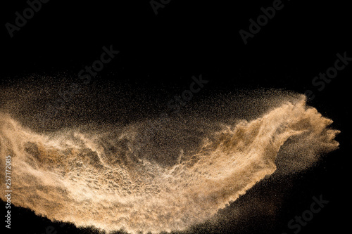 Golden dry river sand explosion isolated on white background. Abstract sand splashing.