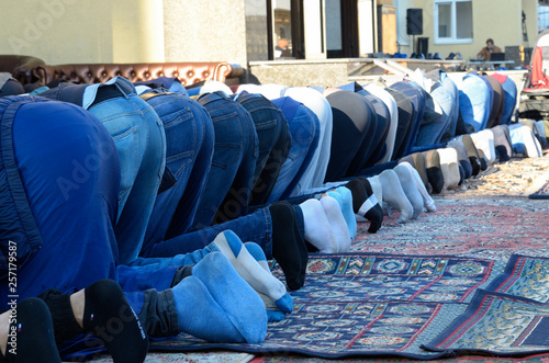 Men (muslims) bending down and praying