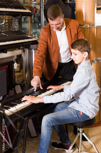 Father and son are looking keyboard