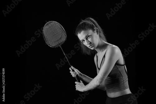 young girl with a rocket plays badminton