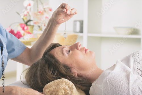 Therapist using pendulum to make a diagnosis