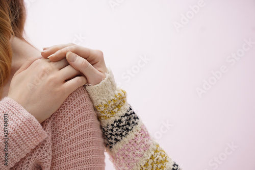 Young woman comforting her friend on color background
