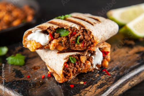 Mexican burrito with beef, beans and sour cream