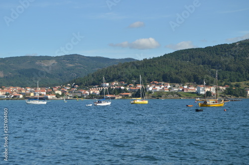 Boats Moored Along With Mussel Breeders In The Estuary Of The Muros Village. Nature, Architecture, History, Street Photography. August 19, 2014. Muros, Pontevedra, Galicia, Spain.