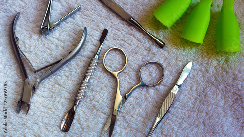 Equipment for beauty shop,cosmetic salon or beauty parlour.Manicure tools in the beauty salon.Equipment for manicure or pedicure salon.Scissors,pliers,tweezers, blade and nail the clamps on the table.