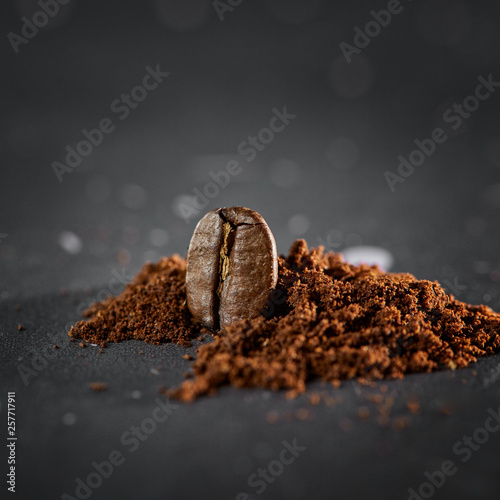 Coffee bean with coffee grounds on a black background