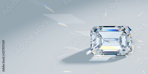 Close-up emerald cut diamond with caustics rays on light blue background