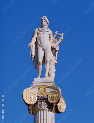 Apollo statue, the ancient greek god of music and poetry on crystal clear blue sky background