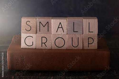 Small Group Spelled in Block Letters on a Table with a Bible