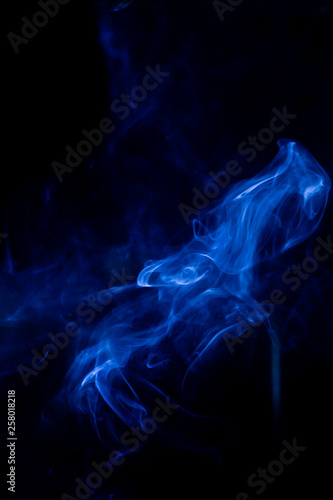 Blue toxic fumes movement on a black background.