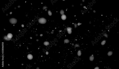 Freeze motion of white snow coming down, isolated on black background. Design texture element.