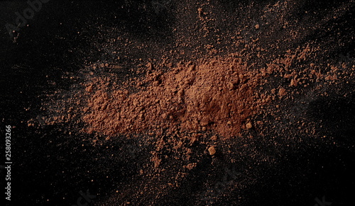 Cocoa powder isolated on black background and texture