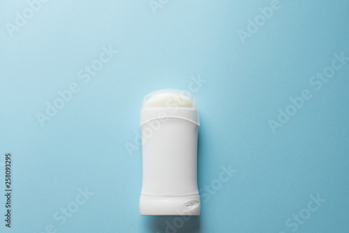 white deodorant on blue background. bath concept. place for text. copy space