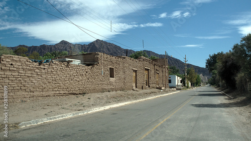 View of typical adobe houses on the town main road, Vinchina, La Rioja, Argentina.