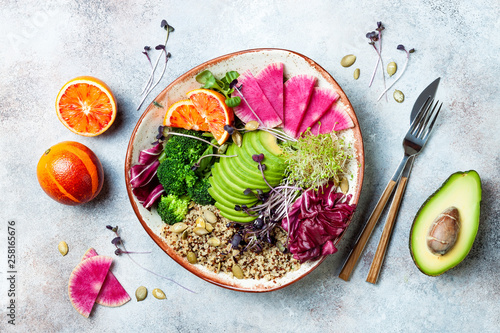 Vegan, detox Buddha bowl with quinoa, micro greens, avocado, blood orange, broccoli, watermelon radish, alfalfa seed sprouts. Top view, flat lay