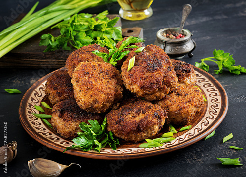 Juicy delicious meat cutlets on a dark table. Russian cuisine.