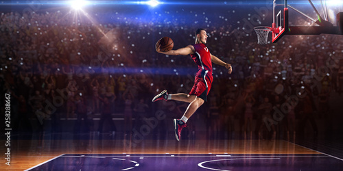 Basketball player in jump. around Arena with blue light spot