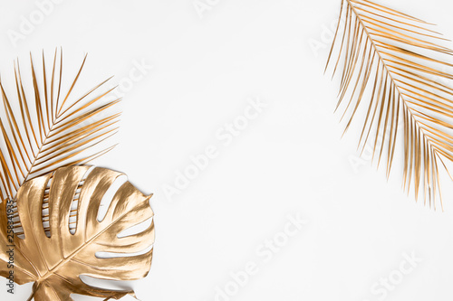 Golden tropical leaves on white background