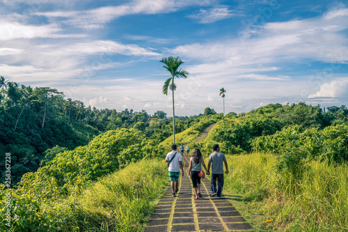 Ubud, Bali, Indonesia - January 2019: tourist taking a guided tour of the ridge walk in Ubud