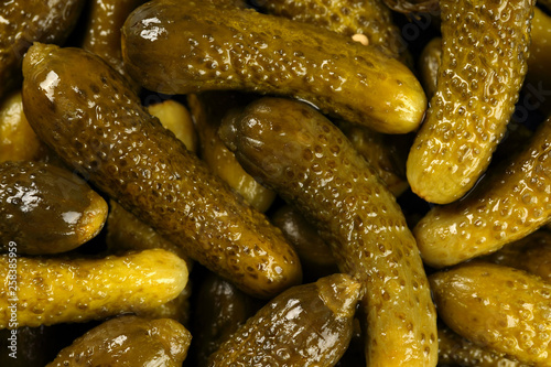 Top view, extreme close up of pickled gherkins (small cucumbers). Macro food texture background with pickles