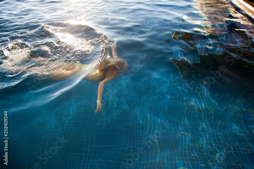 Woman swimming under water