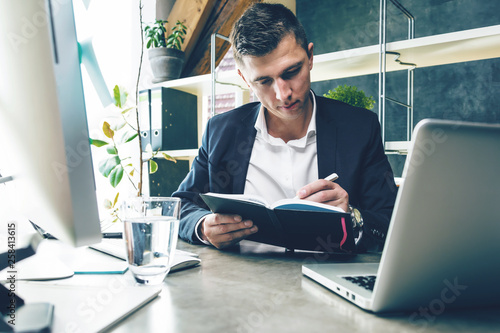 Business man working at office with laptop and documents on his desk