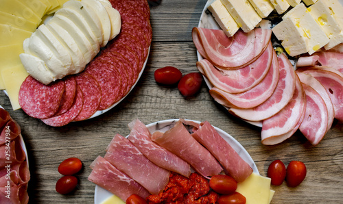 Sliced Cheese And Salami On Plate, wooden background