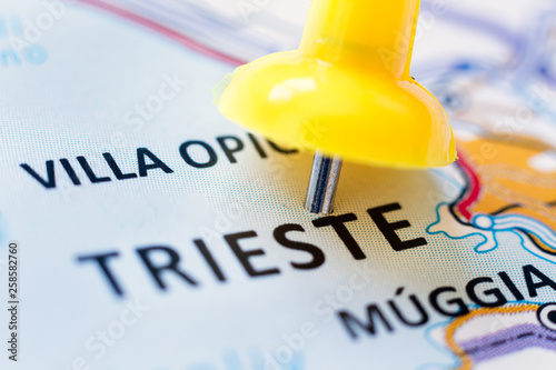 Yellow pin pointing Trieste (Italy) on a map