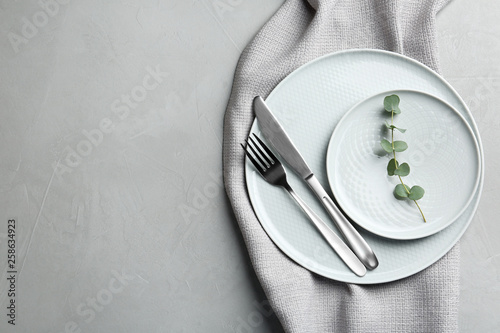 Stylish elegant table setting on light background, top view. Space for text