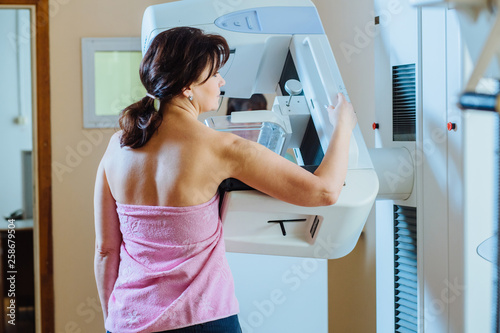 Female patient undergoing mammography test in hospital. Back view, selective focus