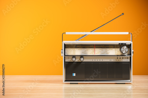 Transistor radio receiver on wood table in home interior. 3d